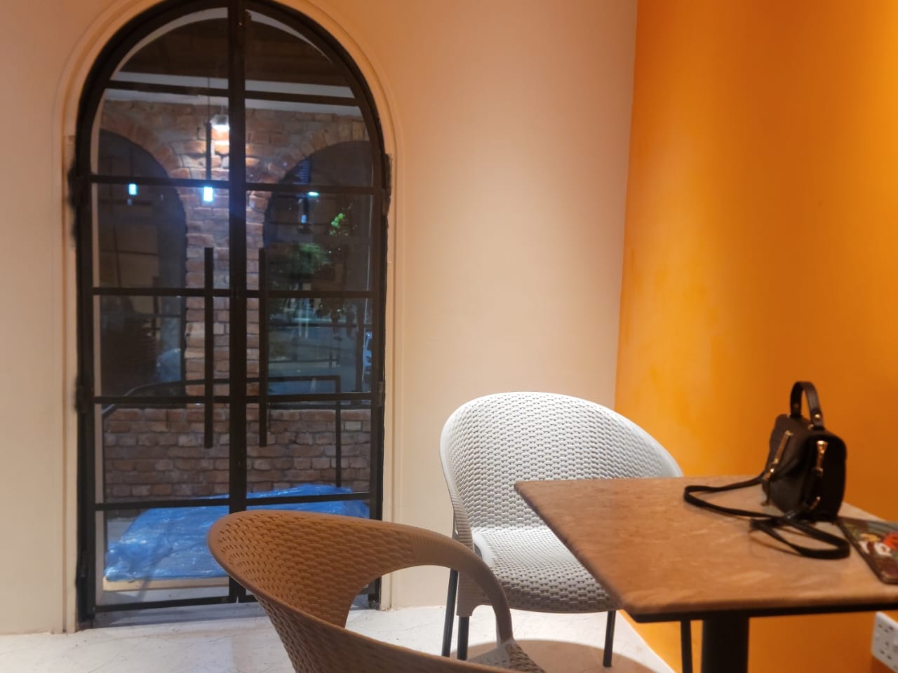 Corner table beside an arched glass door